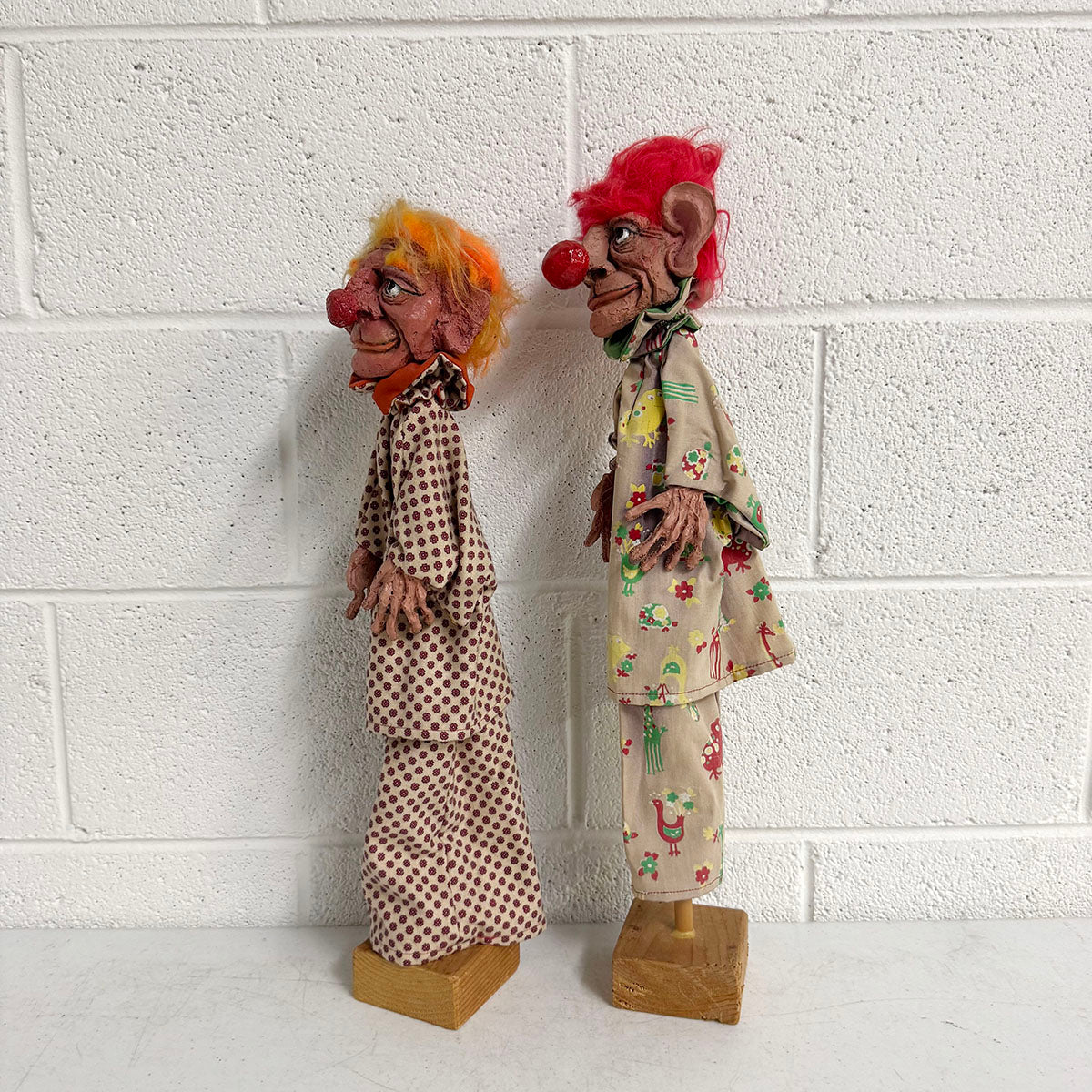 A Pair of Folk Art Clown Puppets on stand