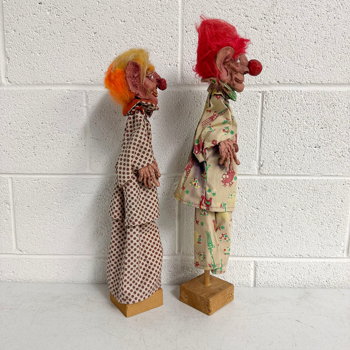 A Pair of Folk Art Clown Puppets on stand