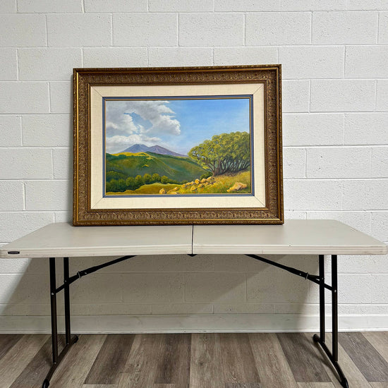 "Landscape Featuring a Meadow with Mountains in the Background" Signed