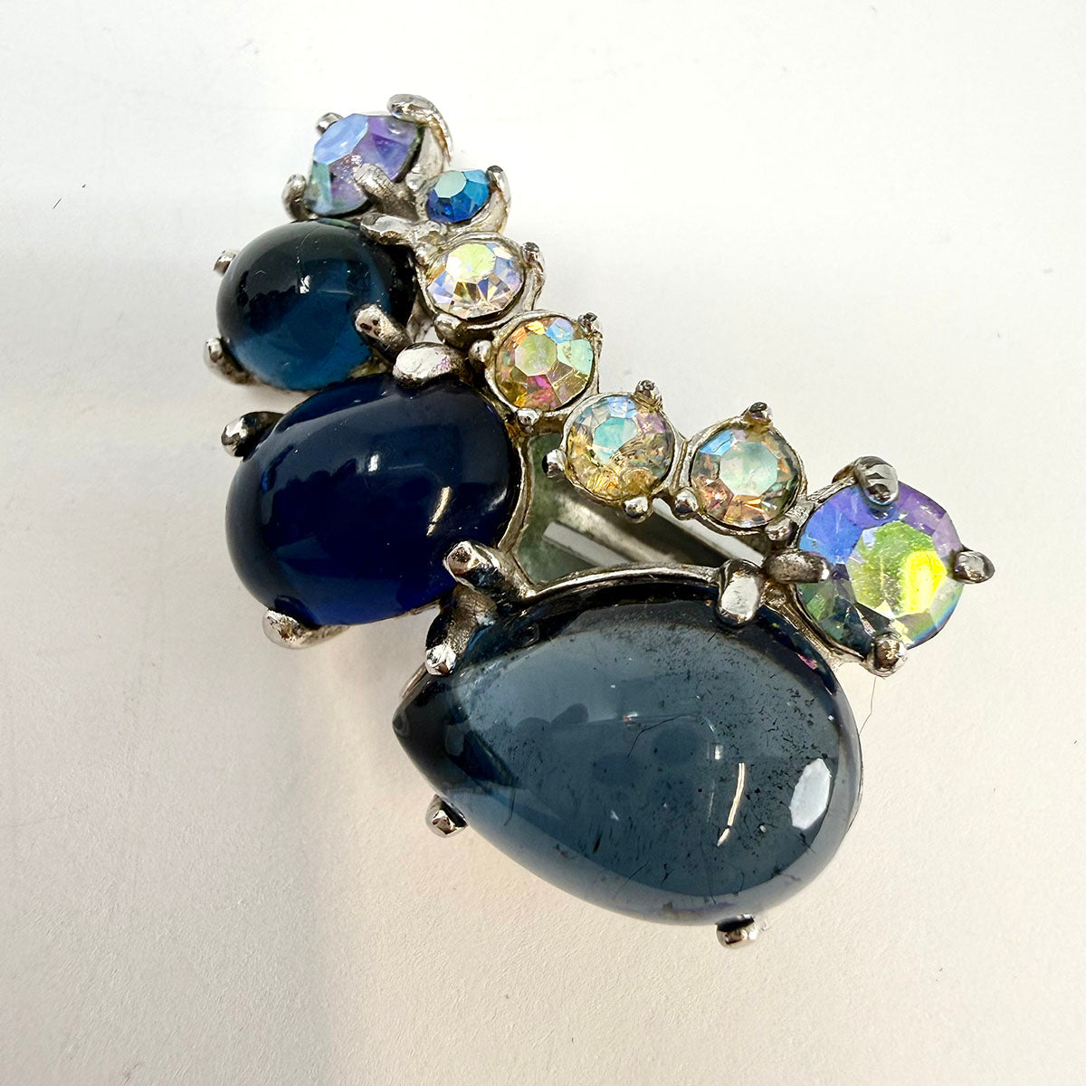 Signed Schiaparelli Curved Clip-on Earrings with Blue Rhinestones
